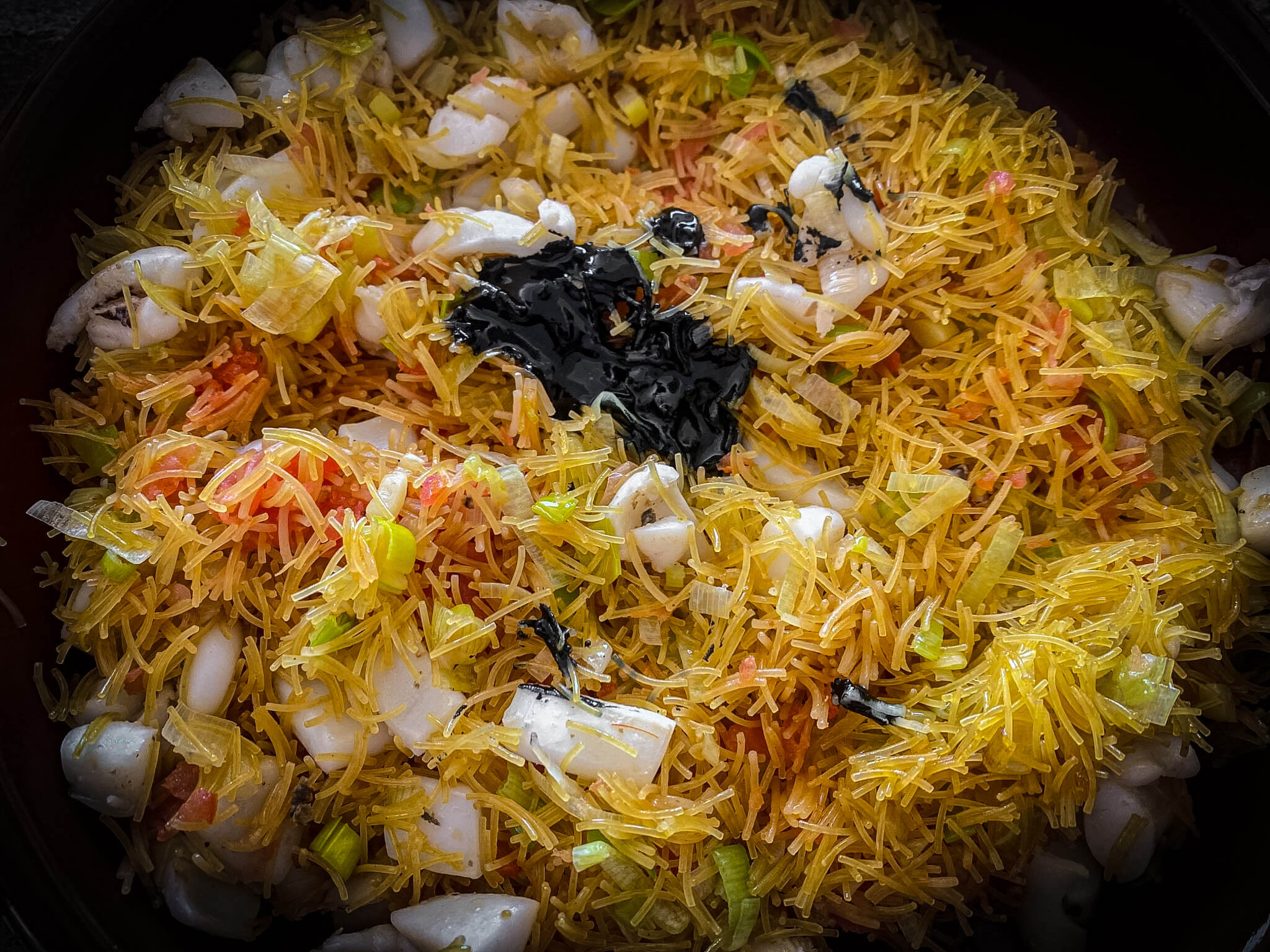 Seafood Black Fideuá with Prawns ink sofrito